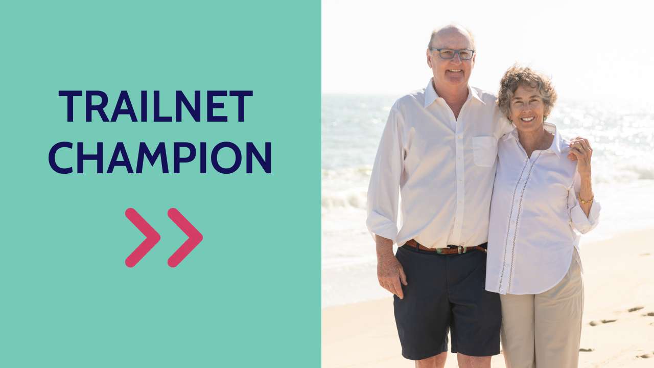 A picture of a man and woman, both in white shirts, smiling. Next to them is a graphic that says Trailnet Champion