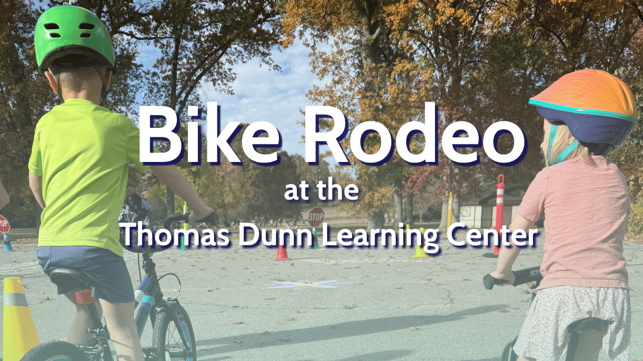 Two children on bikes wearing colorful helmets. The wording says Bike Rodeo at the Thomas Dunn Learning Center.